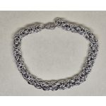 Indás, elegáns karkötő arany-, ezüst-, fekete színű